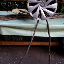 Walking Wheel  
modalities of speed    
wooden branches, sisal rope, reuse of hubcap   
60 x 130 cm   
2025